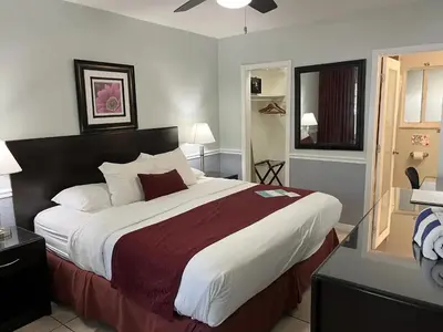 a bedroom with a large bed in a room at The Grand Resort and Spa & Worthington All Male in Fort Lauderdale