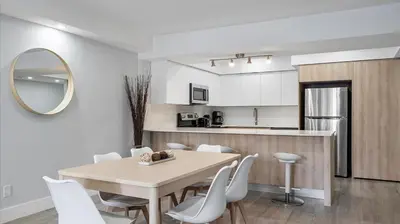 a kitchen and dining room with a table and chairs at Family getaway in Sunny Isles - 2nd floor in Miami Beach