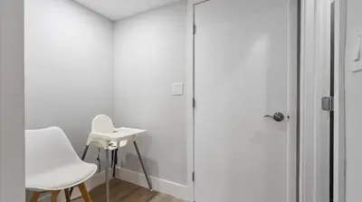 a white room with a white chair and a sink at Family getaway in Sunny Isles - 2nd floor in Miami Beach