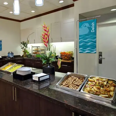 a kitchen with a buffet of food on a counter at Homewood Suites by Hilton Fort Lauderdale Airport-Cruise Port in Dania Beach