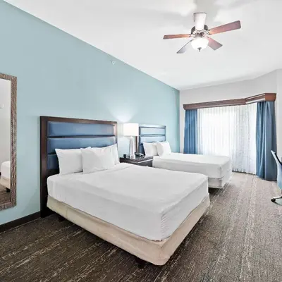 a bedroom with two beds and a ceiling fan at Homewood Suites by Hilton Fort Lauderdale Airport-Cruise Port in Dania Beach