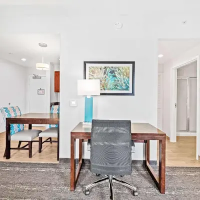 a dining room with a table and a chair at Homewood Suites by Hilton Fort Lauderdale Airport-Cruise Port in Dania Beach