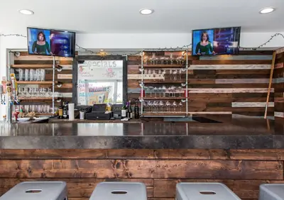 a bar with three stools in front of it at Premiere Hotel in Fort Lauderdale