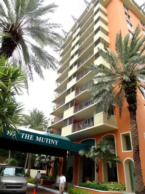 a large building with palm trees in front of it at The Mutiny Luxury Suites Hotel in Miami