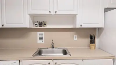 a kitchen with a sink and white cabinets at The Tides-1 bedroom apartment Ground Floor in Hollywood