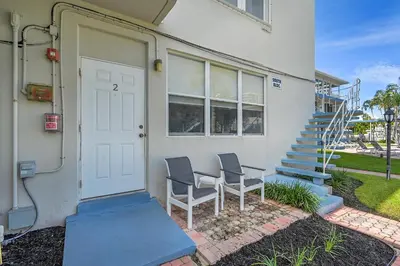 a couple of chairs sitting outside of a house at Holiday Isle Yacht Club in Fort Lauderdale
