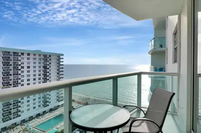 a balcony with a table and chairs and the ocean at THE TIDES 1bedroom apt 15th floor WE ARE ON THE BEACH! in Hollywood