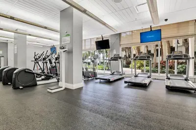 a gym with cardio machines and a flat screen tv at THE TIDES 1bedroom apt 15th floor WE ARE ON THE BEACH! in Hollywood