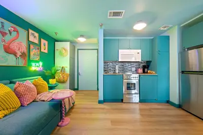 a living room with a couch and a kitchen at Barbizon on Ocean Drive Apartments in Miami Beach