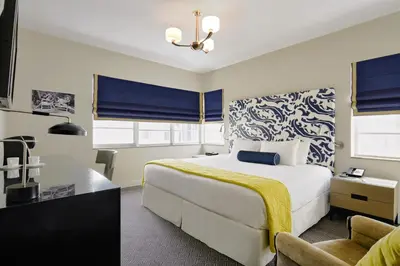 a hotel room with a bed and a chair at Hotel Breakwater South Beach in Miami Beach
