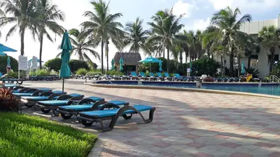 a row of blue benches next to a swimming pool at THE TIDES 1 bedroom apt 8th floor WE ARE ON THE BEACH in Hollywood