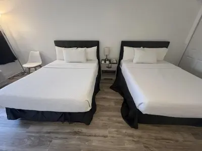 two beds sitting next to each other in a room at Grand Palms Spa & Golf Resort in Pembroke Pines
