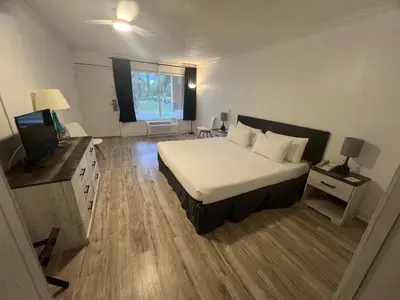 a large bedroom with a bed and a television at Grand Palms Spa & Golf Resort in Pembroke Pines