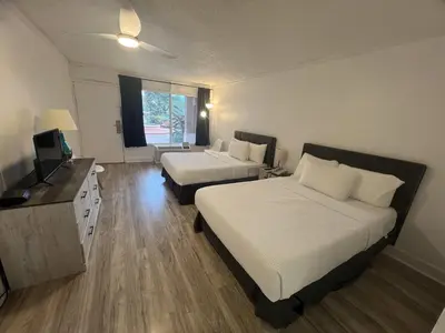 a hotel room with two beds and a television at Grand Palms Spa & Golf Resort in Pembroke Pines