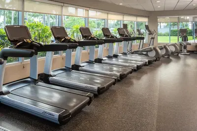a row of tread machines in a gym at Residence Inn by Marriott Miami Airport in Miami