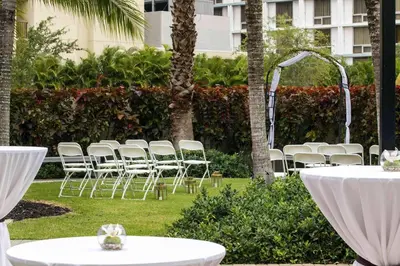 a group of white chairs and tables in a park at Residence Inn by Marriott Miami Airport in Miami
