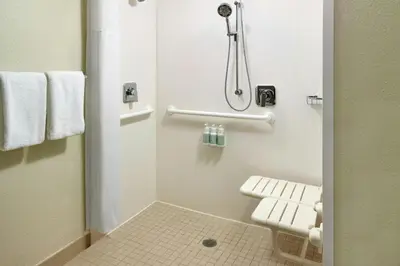 a small bathroom with a toilet and a shower at Courtyard Miami Airport West Doral in Miami