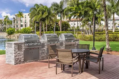 a patio with a grill and a table and chairs at Marriott's Villas At Doral in Miami