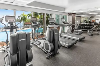 a gym with cardio equipment and a swimming pool at Marriott's Villas At Doral in Miami
