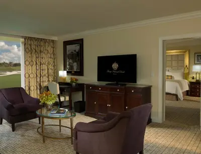 a living room with a television and a bedroom at Trump National Doral Golf Resort in Miami