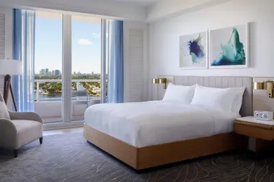 a bedroom with a large bed and a large window at The Ritz-Carlton, Fort Lauderdale in Fort Lauderdale