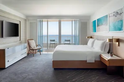 a hotel room with a large bed and a television at The Ritz-Carlton, Fort Lauderdale in Fort Lauderdale