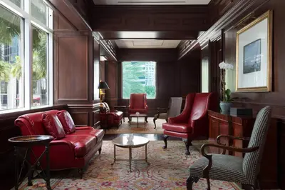 a living room with red leather furniture and windows at JW Marriott Miami in Miami