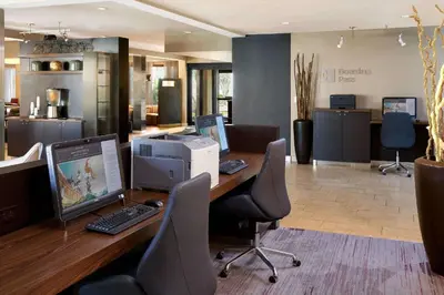 an office with a desk with a computer and chairs at Sonesta Select Miami Lakes in Miami Lakes
