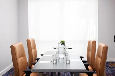 a dining room with a table and chairs at Courtyard Miami Dadeland in Miami