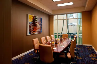 a conference room with a long table and chairs at Courtyard Miami Dadeland in Miami