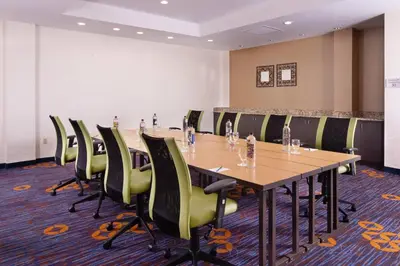a conference room with a long table and chairs at Courtyard Miami Coral Gables in Miami