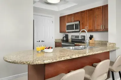 a kitchen with a granite counter top with a sink at Marriott's BeachPlace Towers in Fort Lauderdale