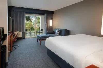 a hotel room with a bed and a chair at Courtyard Fort Lauderdale SW Miramar in Miramar