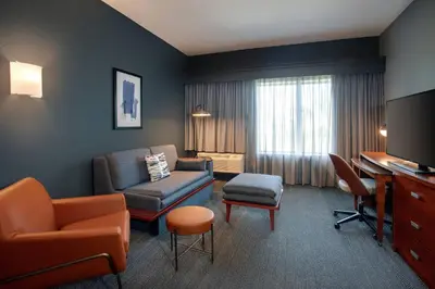 a living room with a couch chair and a desk at Courtyard Fort Lauderdale SW Miramar in Miramar