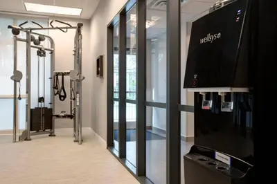a room with a gym with a television and a simulator at Courtyard Fort Lauderdale SW Miramar in Miramar