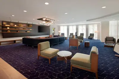 a lobby with a waiting room with chairs and a table at Courtyard Fort Lauderdale SW Miramar in Miramar