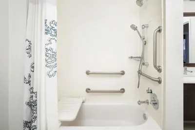 a white bathroom with a tub and a shower at Residence Inn by Marriott Fort Lauderdale City of Plantation in Plantation