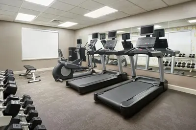 a gym with treadmills and ellipticals in a room at Residence Inn by Marriott Fort Lauderdale City of Plantation in Plantation