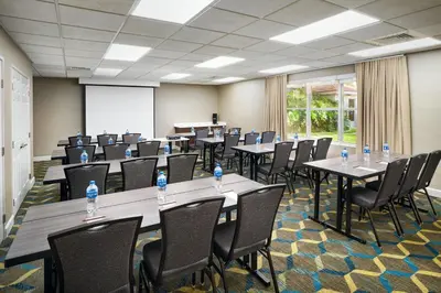 a conference room with tables and chairs and a whiteboard at Residence Inn by Marriott Fort Lauderdale City of Plantation in Plantation