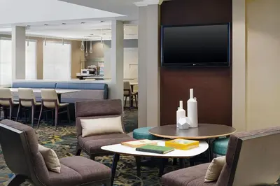 a waiting room with chairs and a table and a tv at Residence Inn by Marriott Fort Lauderdale City of Plantation in Plantation