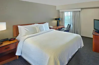 a hotel room with a large bed and a television at Residence Inn by Marriott Fort Lauderdale Weston in Weston