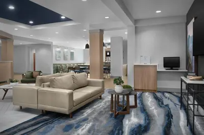 a living room with a couch and a tv at Fairfield Inn & Suites Fort Lauderdale Airport & Cruise Port in Dania Beach