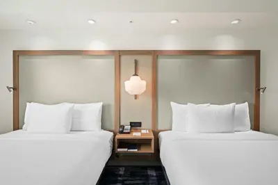 two beds sitting next to each other in a hotel room at Fairfield Inn & Suites Fort Lauderdale Airport & Cruise Port in Dania Beach