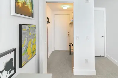 a hallway of a home with art on the walls at Luxurious Hyde Resort Apartments in Hollywood