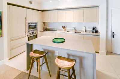 a kitchen with a counter and two stools at Luxurious Hyde Resort Apartments in Hollywood