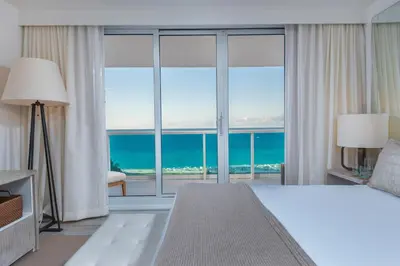 a bedroom with a bed and a view of the ocean at Oceanview Private Condo at 1 Hotel & Homes -1144 in Miami Beach