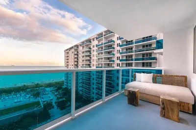 a balcony with a bed and a view of the ocean at Oceanview Private Condo at 1 Hotel & Homes -1144 in Miami Beach
