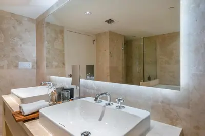 a bathroom with two sinks and a large mirror at Oceanview Private Condo at 1 Hotel & Homes -1144 in Miami Beach