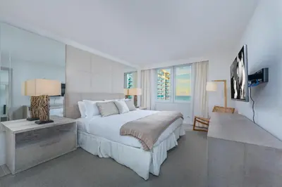 a bedroom with a large white bed and a television at Oceanview Private Condo at 1 Hotel & Homes -1144 in Miami Beach
