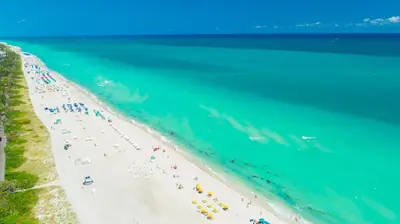 an overhead view of a beach with a group of people at Oceanfront Private Condo at 1 Hotel & Homes -1019 in Miami Beach